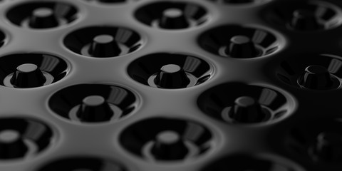 Repetitive donuts pattern being inset at the black smooth surface. 3D abstract illustration.