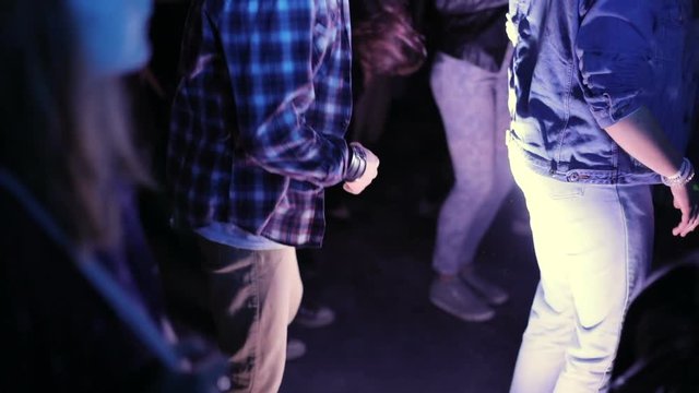 Young man dancing on the dancefloor of the nightclub. Neon throng fans concert concert-hall party nightlife clublife superstars Fashion glamour