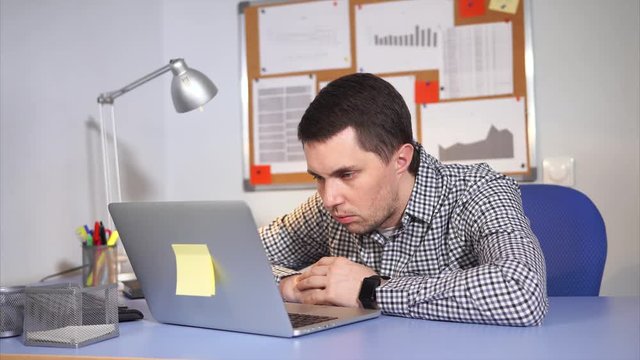 Office worker work hard using laptop. He tired and exhausted so he get sleeped at work.