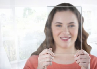 Woman holding glass screen by bright sunny window