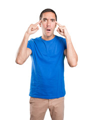 Shocked young man with a gesture of concentration against white background