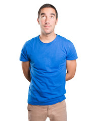 Fototapeta premium Astonished young man looking up against white background