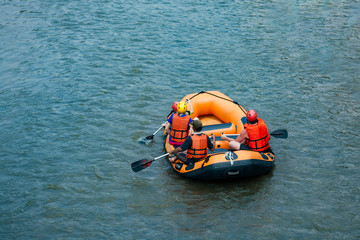 Group of traveler in the inflatable rafting on the river, extreme and fun sport