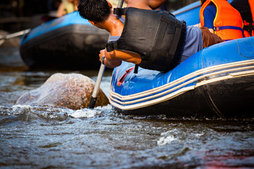 Close-up of young person rafting on the river, extreme and fun sport at tourist attraction