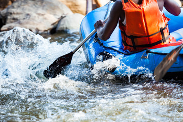 Close-up of young person rafting on the river, extreme and fun sport at tourist attraction - obrazy, fototapety, plakaty