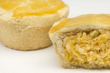 Two traditional Brazilian mini chicken pie called empada with one cut close