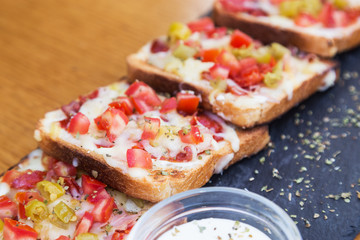Tost bread Breakfast ham sheet and salad with sauce on dark board. Isolated on wooden background.  