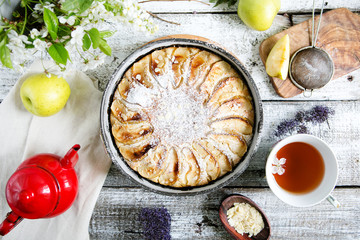 Homemade apple pie in rustic style, on a wooden background, top view