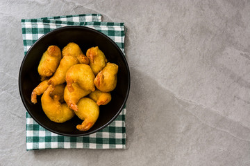 Deep fried shrimps in a bowl on gray stone
