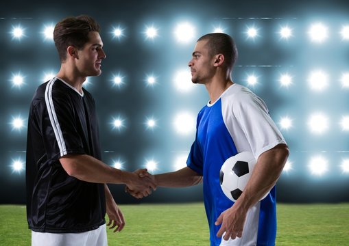 soccer players giving the hand in the field - Powered by Adobe