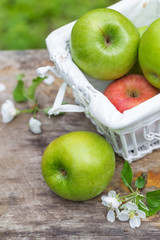 Fresh sweet juicy green apples with flowers wood