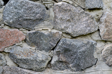 Old stone wall made of huge granite