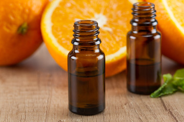 Orange essential oil and fresh orange