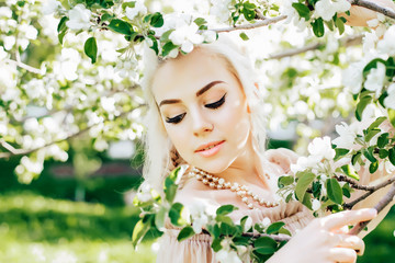 Beautiful bride in a blossoming garden close-up face