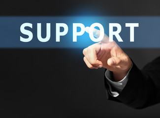 Male hand with finger pointing on dark background