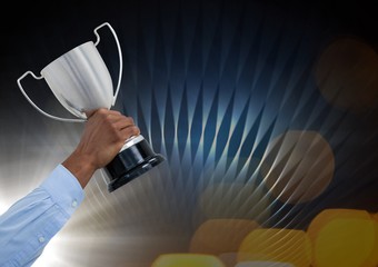 Business hand with trophy and blue and yellow background 