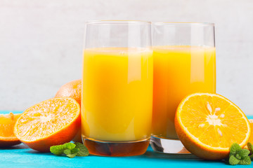 Fototapeta na wymiar Orange juice - two glasses on blue wooden table