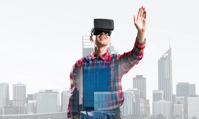 Guy wearing checked shirt and virtual mask stretching hand to touch something