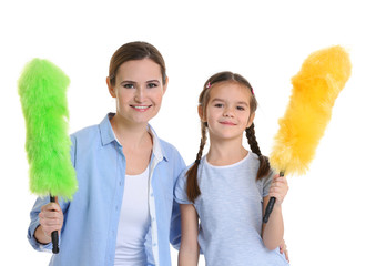 Mother and daughter with dusters, isolated on white