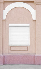 Window with closed blinds on old building