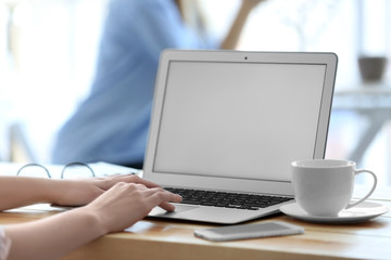 Woman working on laptop at table