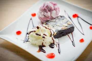 Homemade brownies with vanilla ice cream and whipped cream.(selective focus)