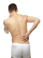 Young man suffering from back pain on white background