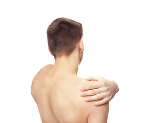 Young man suffering from pain in shoulder on white background