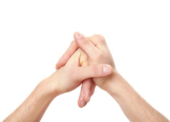 Hands of young man suffering from pain in joints on white background