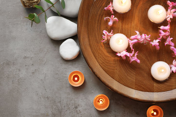Beautiful spa composition with flowers and candles on water