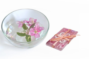 Fototapeta na wymiar Natural handmade floral soap and cherry blooms in the water