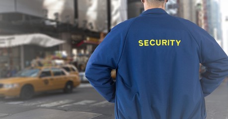 Back of security guard against blurry street