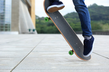 Skateboarder legs skateboarding at city