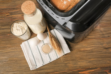 Ingredients for cooking in bread machine on wooden background