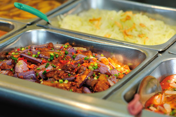 Steel tray filled with food inside the self service Chinese restaurant