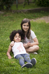 two adorable multi ethnic girls outdoors having fun