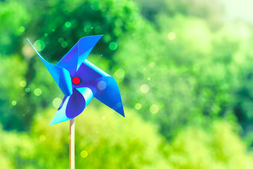 Blue paper weathercock on nature background