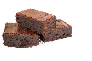Sliced homemade brownies tower on white background. Sweet and moist of chocolate dessert.
