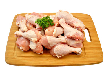 Raw Fresh Chicken Legs on a Wooden Cutting Board 