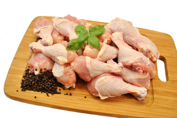 Raw Fresh Chicken Legs on a Wooden Cutting Board 