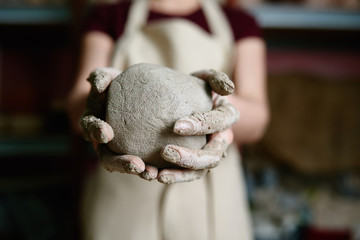 Potter holds a ball of clay