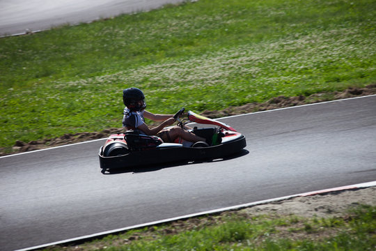 young man drive go kart on track