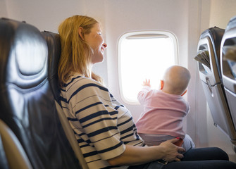 Mother and baby traveling on plane