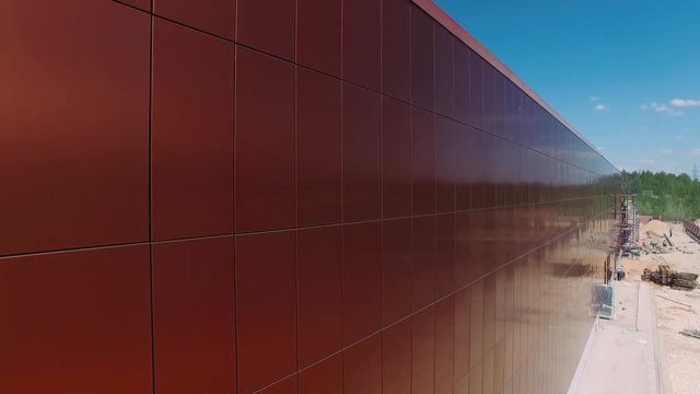 Modern building of aluminium and glass, ventilated facade, construction. 4k. Aerial view. 
