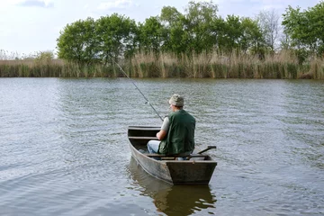 Foto op Canvas river fishing- man catching fish. © Lucky Fenix