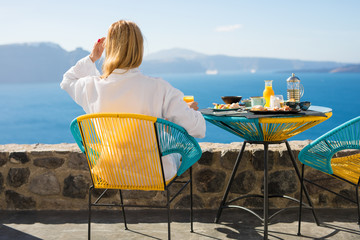 Obraz premium Woman enjoying morning in luxury hotel in Santorini