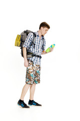 Young tourist with  backpack drinking water on white background