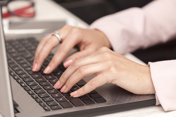 Close-up of typing female hands on keyboard