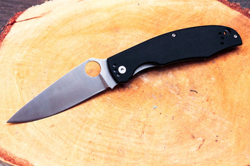Knife with a triangular blade. White blade and black handle.