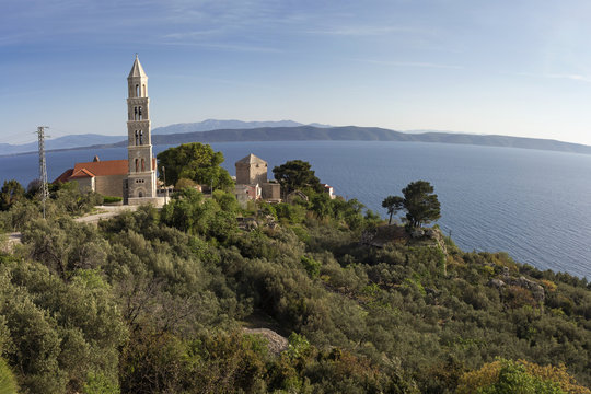 Church Bell tower and Zale tower in Igrane tourist town on Makarska Riviera on the Adriatic coast below Biokovo in Croatia